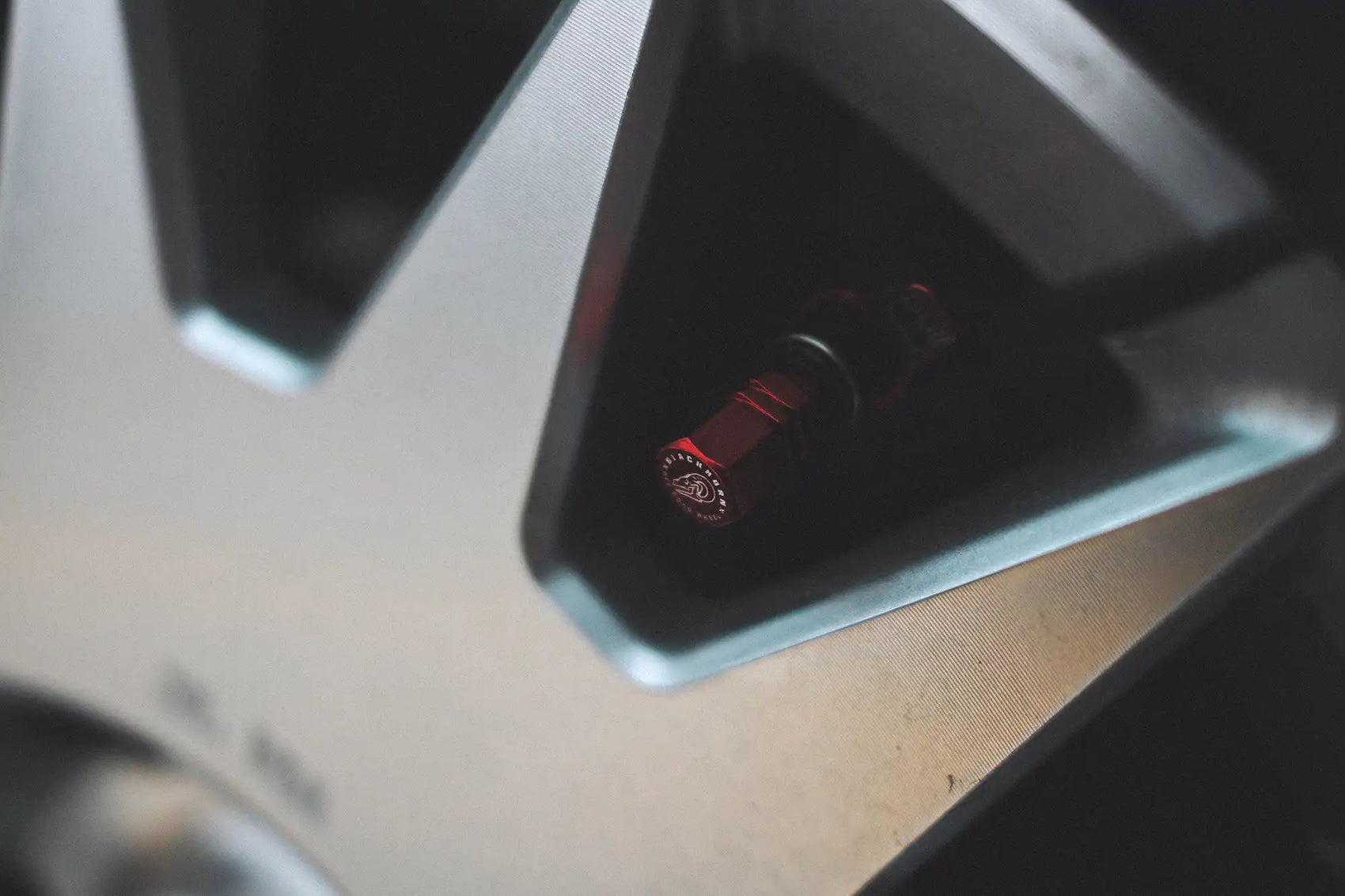 Red Blackhorn valve stem cap installed on GR17 wheel in Prism finish.