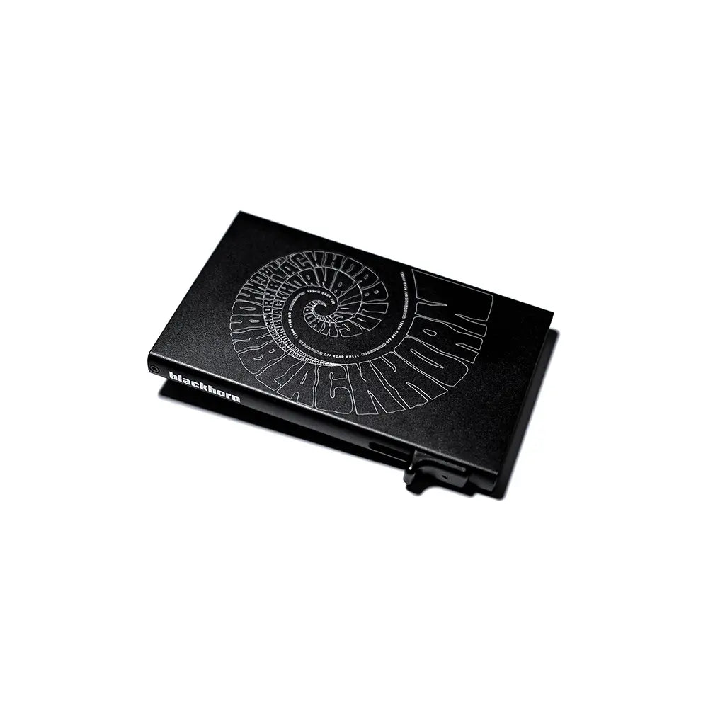 Angled view of Aluminum Card Holder showing engraved spiral graphic on front and Blackhorn logo on the side.