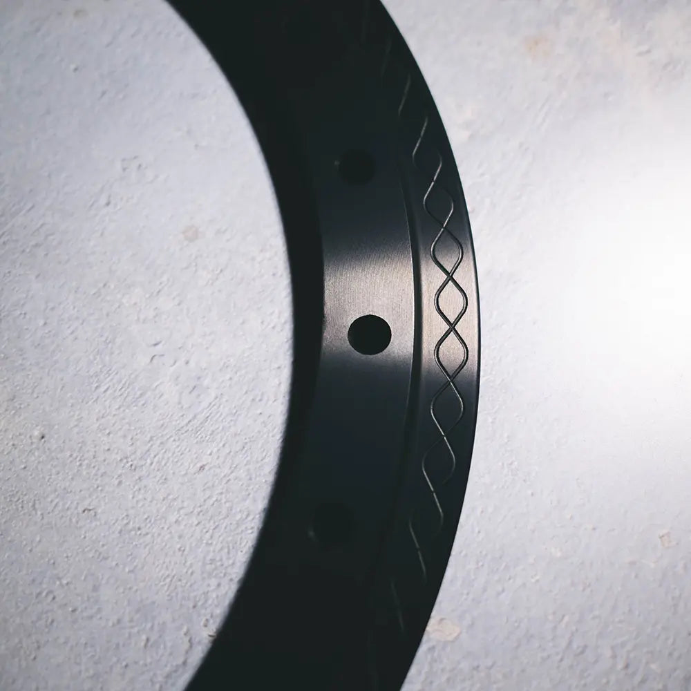 Close-up of Type 01 beadlock ring in black anodized finish highlighting solid edge and knurled fishtail clamp surface