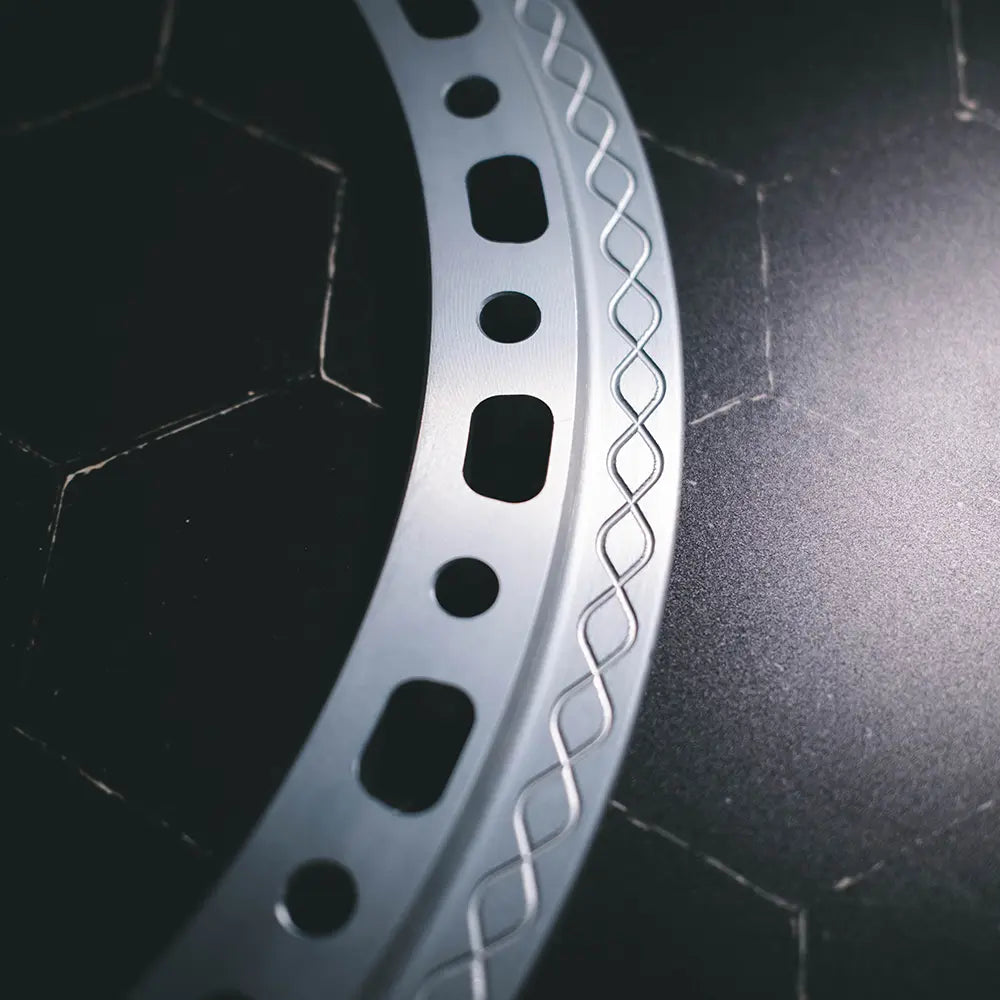 Close-up of Type 02 beadlock ring in anodized finish showing cut-out design and knurled fishtail clamp surface detail