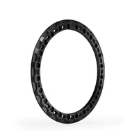 Corner angle black anodized beadlock ring showing sculpted relief edges and recessed hardware pockets.