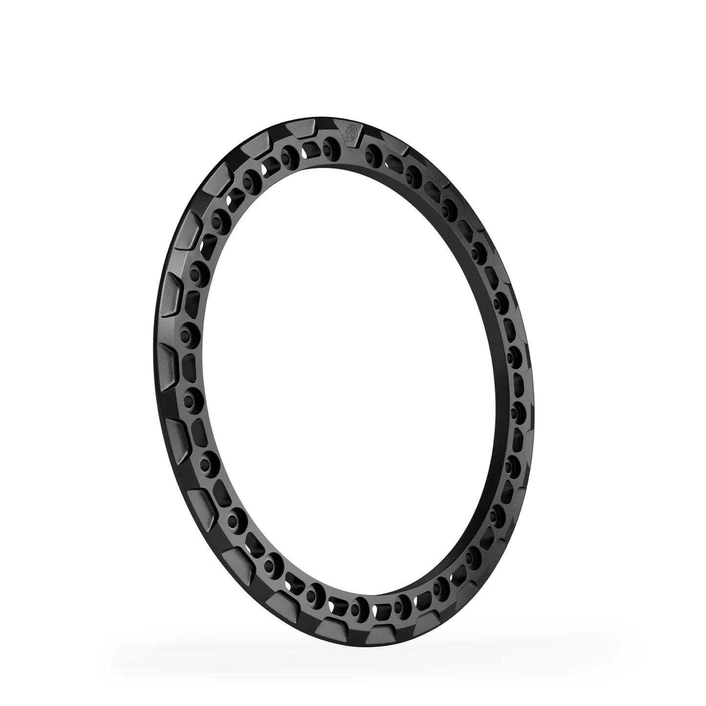 Cut-out beadlock ring with trapezoid relief in black anodized finish, forged 6061-T6 aluminum, 24-hole pattern.